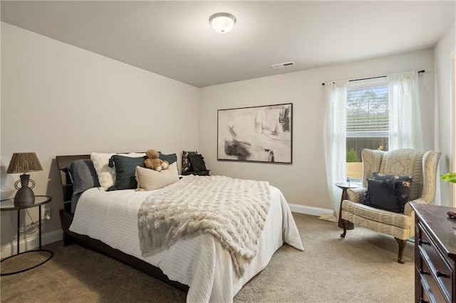 carpeted bedroom featuring baseboards and visible vents