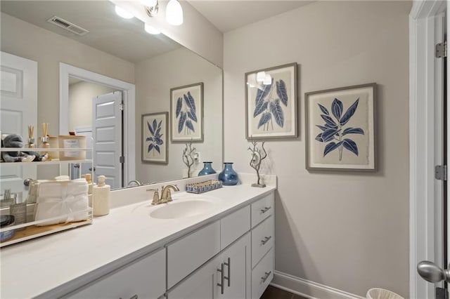 bathroom featuring visible vents, vanity, and baseboards