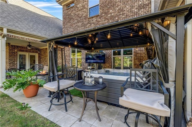 view of patio / terrace with a ceiling fan, an outdoor fire pit, and a gazebo