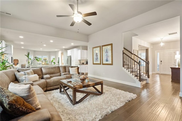 living room with stairs, baseboards, dark wood finished floors, and recessed lighting