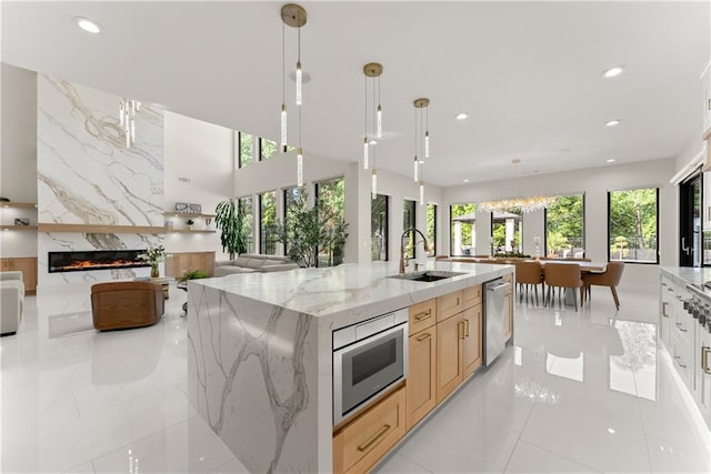 1336 Azalea Dr, Lawrenceville, GA 30043 - kitchen with open floor plan, a sink, stainless steel dishwasher, recessed lighting, and light tile patterned floors