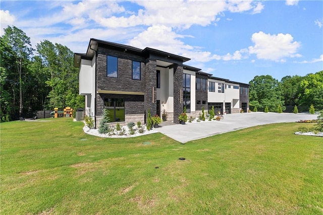 1336 Azalea Dr, Lawrenceville, GA 30043 - view of front of property with stone siding, a front yard, central AC unit, and a playground