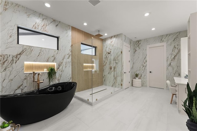 1336 Azalea Dr, Lawrenceville, GA 30043 - full bath featuring a freestanding tub, a marble finish shower, recessed lighting, tile walls, and vanity