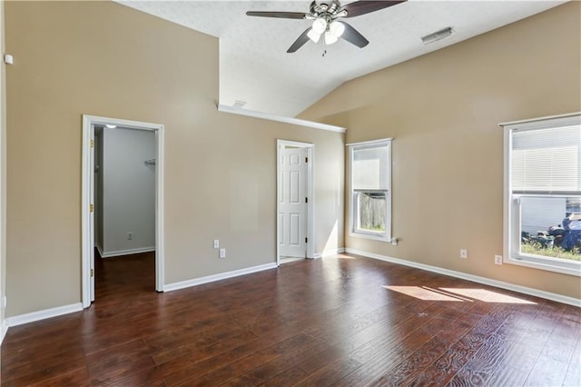 unfurnished bedroom with lofted ceiling, visible vents, and multiple windows