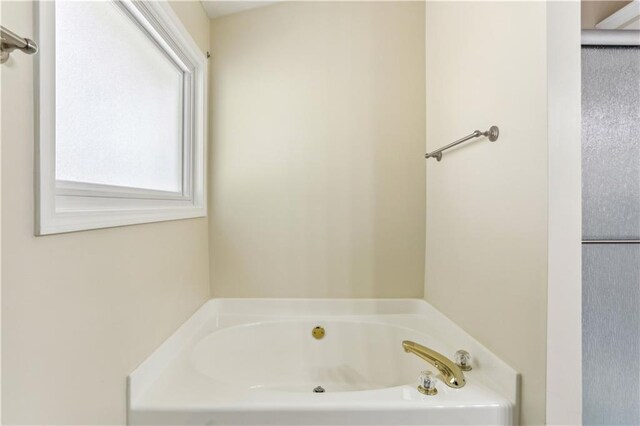 full bath with a garden tub