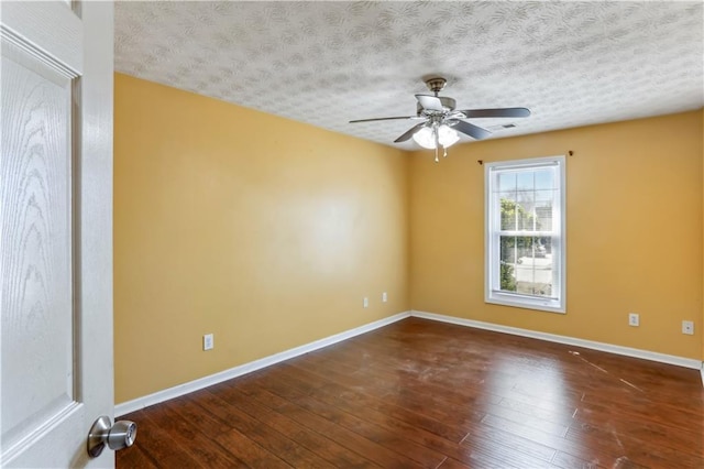 empty room with baseboards, a textured ceiling, ceiling fan, and hardwood / wood-style floors