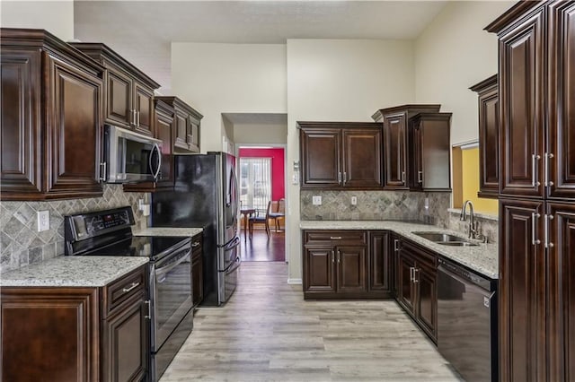 kitchen with a sink, electric range oven, stainless steel microwave, black dishwasher, and dark brown cabinets