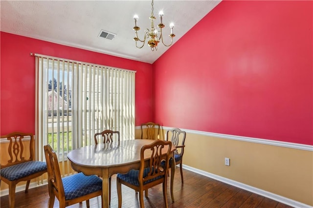 dining room with plenty of natural light, lofted ceiling, visible vents, and an inviting chandelier