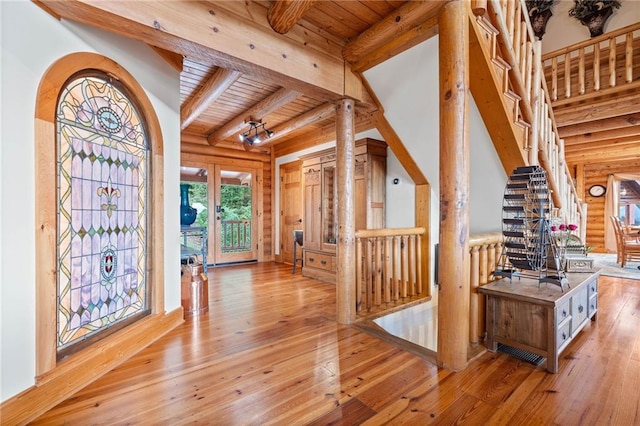 foyer with wooden ceiling, beam ceiling, and light hardwood / wood-style flooring