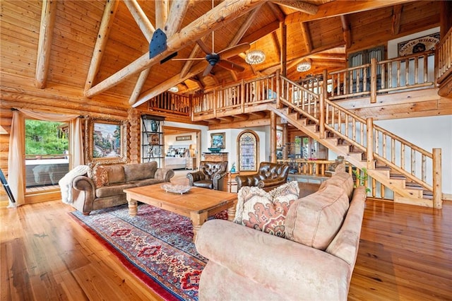 living room featuring wood-type flooring, beam ceiling, high vaulted ceiling, and wooden ceiling