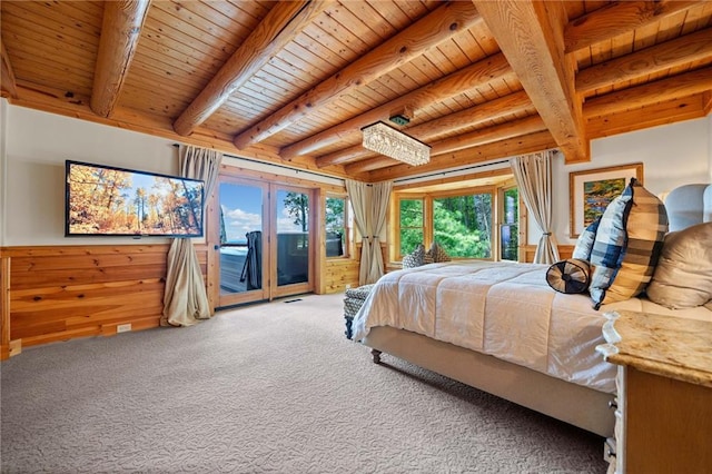 bedroom with access to outside, beam ceiling, and multiple windows