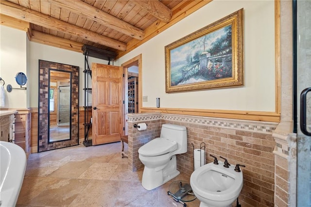 bathroom with vanity, beamed ceiling, wood ceiling, a bidet, and toilet