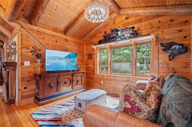 living room with wooden walls, light wood-type flooring, and wooden ceiling