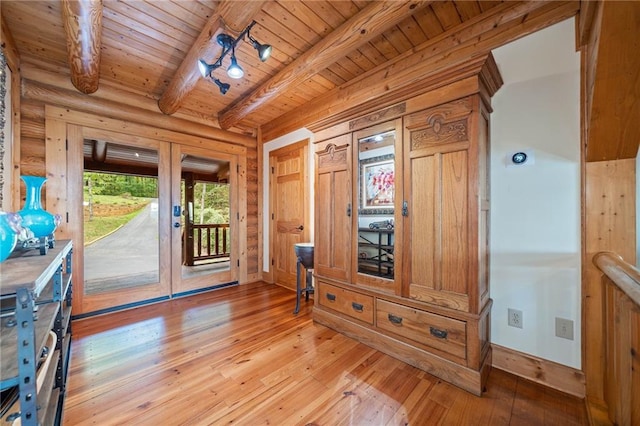 mudroom with light hardwood / wood-style flooring, beam ceiling, and wood ceiling