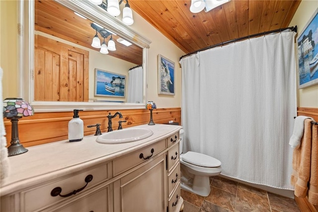 bathroom featuring wood walls, wooden ceiling, vanity, and toilet