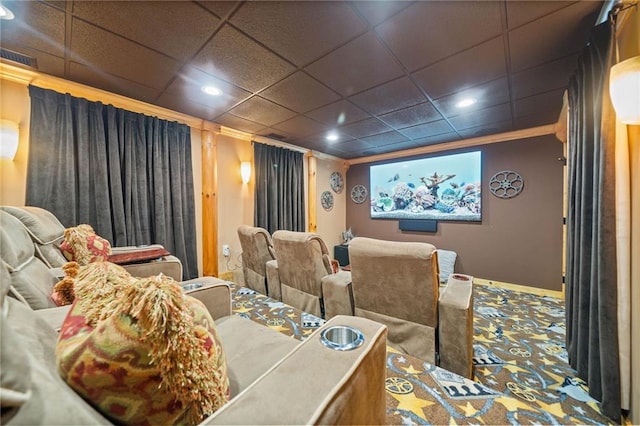 carpeted cinema featuring a drop ceiling and ornamental molding