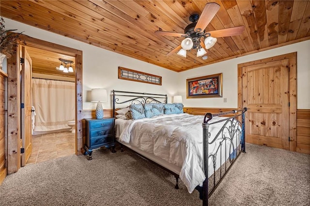 bedroom with wooden walls, ceiling fan, wooden ceiling, and carpet flooring