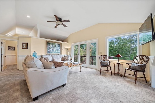 living room with light carpet, vaulted ceiling, and ceiling fan