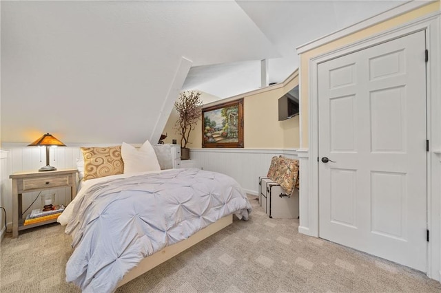 bedroom featuring vaulted ceiling and light colored carpet