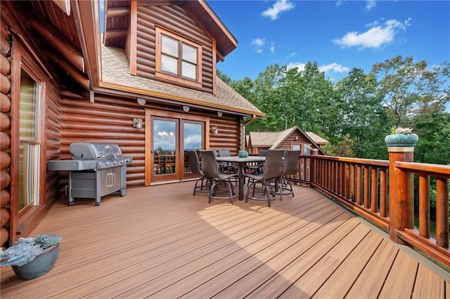 wooden deck featuring a grill