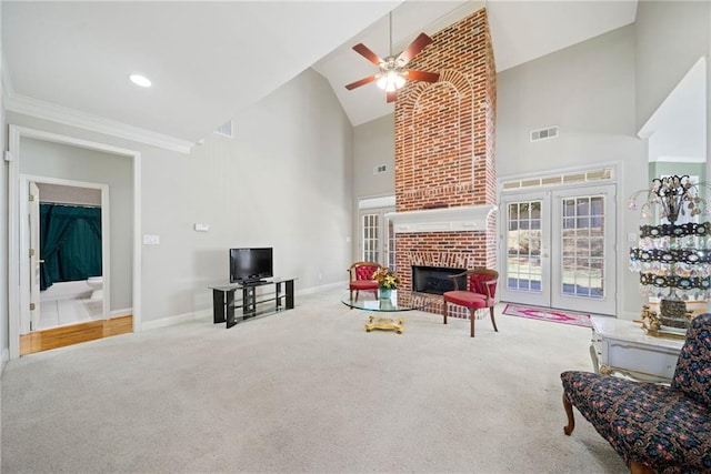 living room with baseboards, visible vents, carpet floors, a fireplace, and ceiling fan