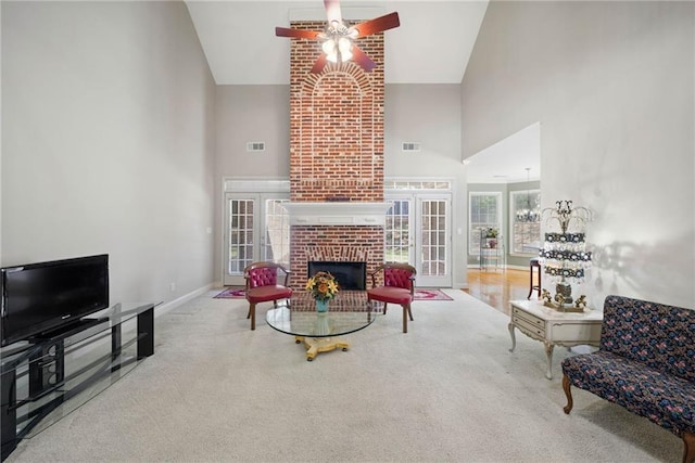 living area featuring baseboards, high vaulted ceiling, carpet, and ceiling fan