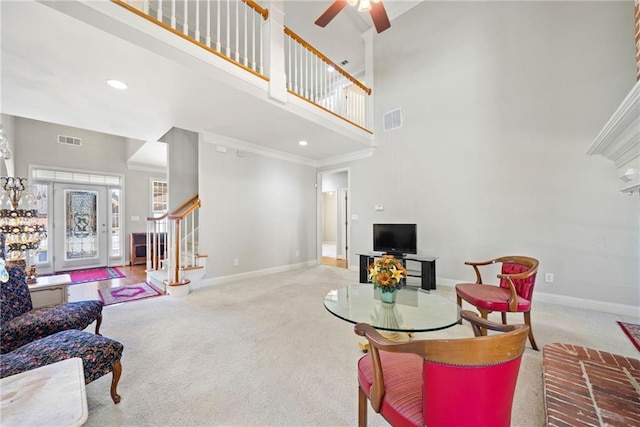 living room featuring stairs, baseboards, and visible vents