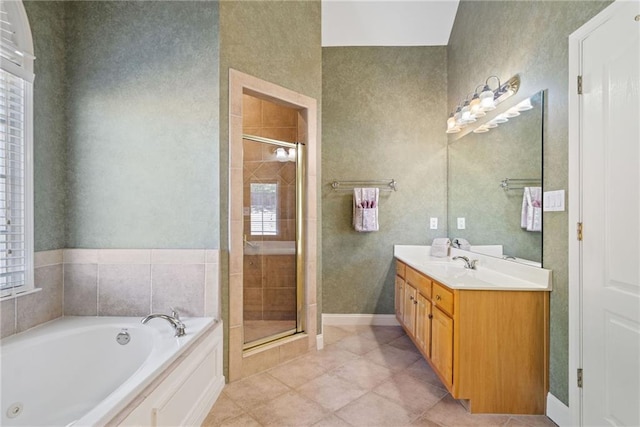 bathroom featuring tile patterned floors, a stall shower, vanity, and a garden tub