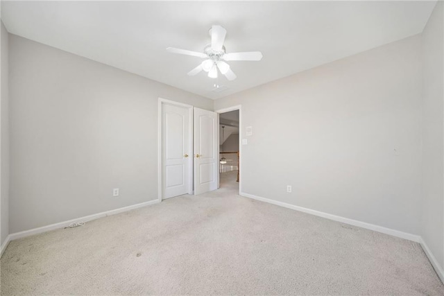 unfurnished bedroom featuring carpet flooring, a ceiling fan, and baseboards