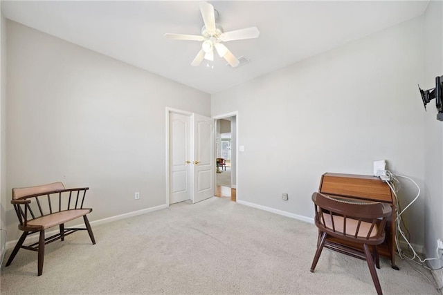 living area featuring baseboards, carpet floors, visible vents, and a ceiling fan