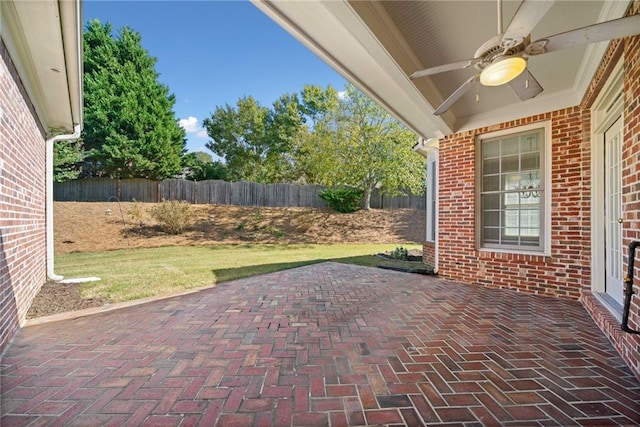 view of patio / terrace featuring ceiling fan and fence