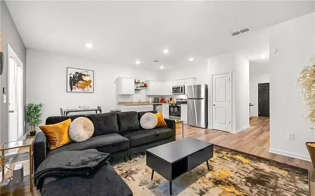 living room with light hardwood / wood-style flooring