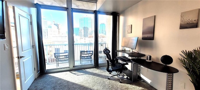 office area featuring dark carpet and a wall of windows