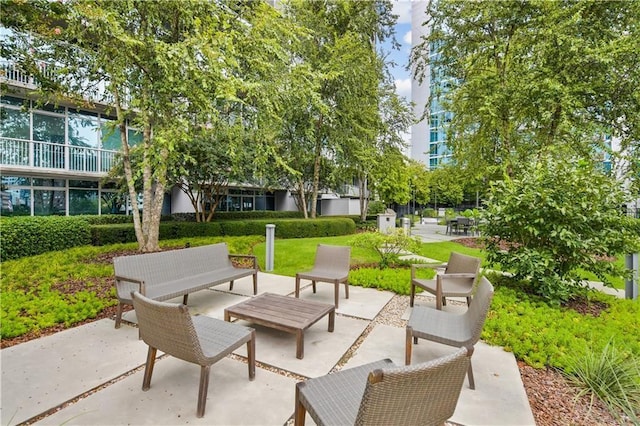 view of community with a patio and an outdoor living space