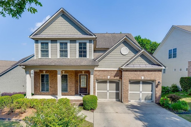7719 Copper Kettle Way, Flowery Branch, GA 30542 - craftsman-style home featuring concrete driveway, covered porch, brick siding, an attached garage, and a shingled roof