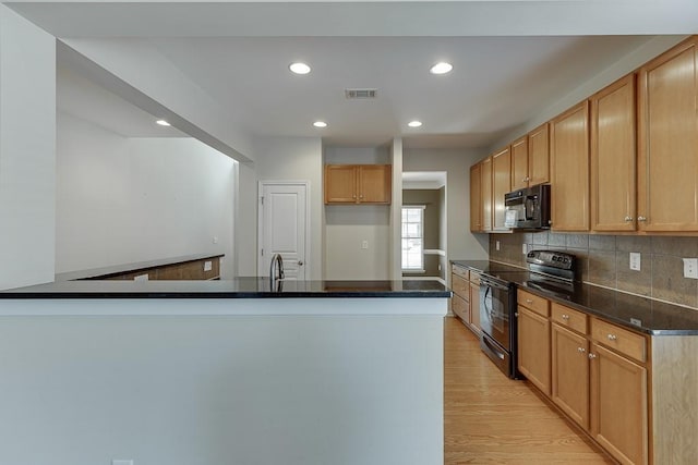 7719 Copper Kettle Way, Flowery Branch, GA 30542 - kitchen with black appliances, light wood-style floors, recessed lighting, tasteful backsplash, and a peninsula