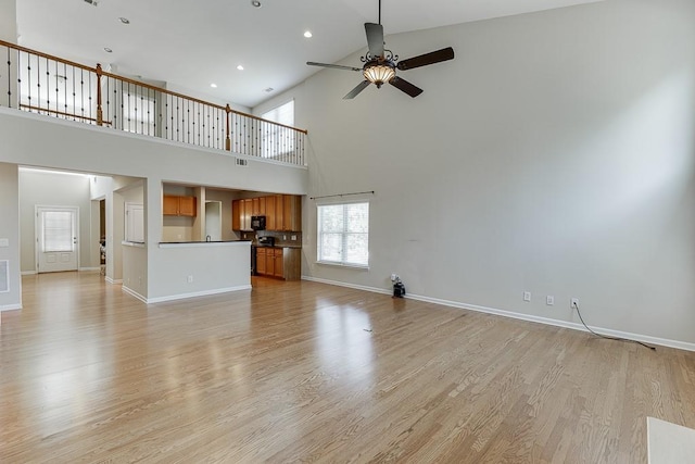7719 Copper Kettle Way, Flowery Branch, GA 30542 - unfurnished living room featuring ceiling fan, high vaulted ceiling, light wood-type flooring, and recessed lighting