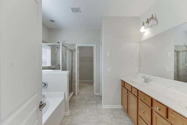 7719 Copper Kettle Way, Flowery Branch, GA 30542 - full bath featuring a stall shower, a garden tub, double vanity, tile patterned flooring, and a spacious closet