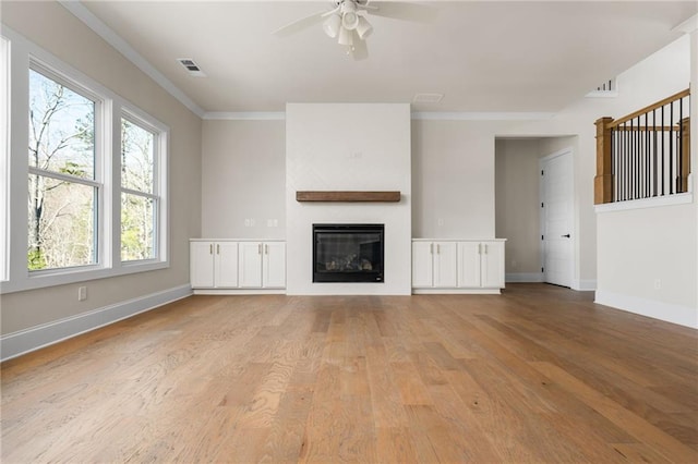 unfurnished living room featuring light hardwood / wood-style floors, crown molding, and ceiling fan