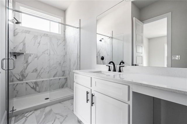 bathroom featuring vanity and a shower with door