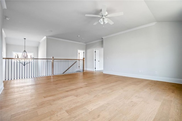 unfurnished room featuring ceiling fan with notable chandelier, light hardwood / wood-style flooring, and crown molding