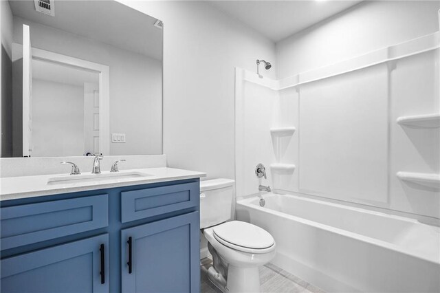 full bathroom featuring vanity,  shower combination, and toilet