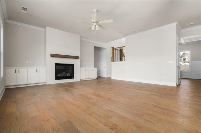 unfurnished living room with ceiling fan, ornamental molding, and light hardwood / wood-style floors