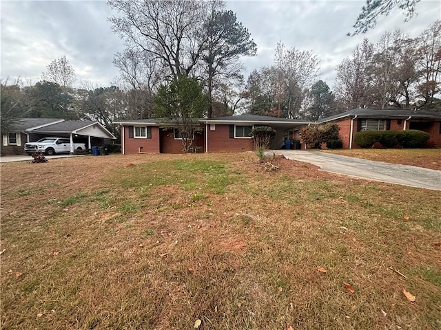 ranch-style home with a carport and a front lawn