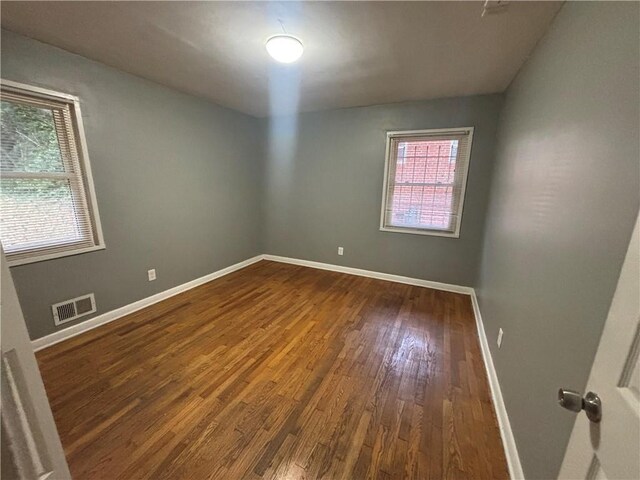 empty room with hardwood / wood-style floors