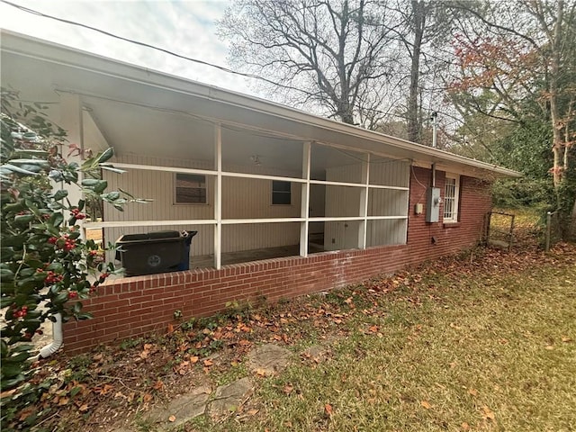 view of property exterior featuring a sunroom