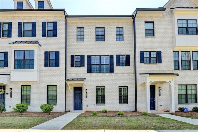 townhome / multi-family property featuring brick siding