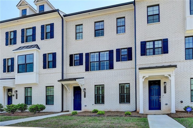 townhome / multi-family property with brick siding