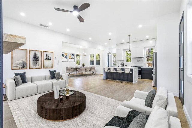 1247 Bridges Ave SW Unit B, Atlanta, GA 30310 - living room featuring light wood-type flooring, ceiling fan, a chandelier, recessed lighting, and baseboards