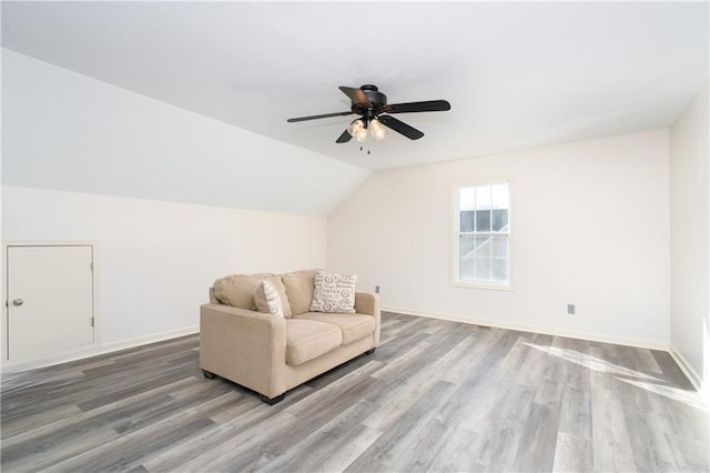 unfurnished room featuring ceiling fan, wood-type flooring, and lofted ceiling